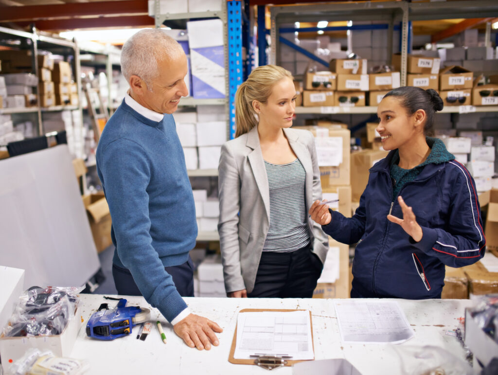 Managers talking to warehouse staff