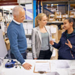 Managers talking to warehouse staff